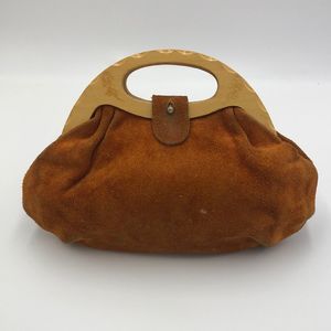 Vintage 1970s era leather handbag with wooden handles and engraved flowers